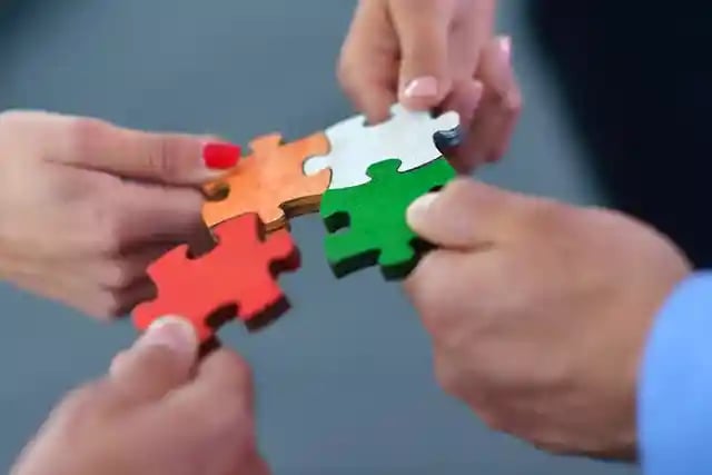 Group of business people assembling jigsaw puzzle