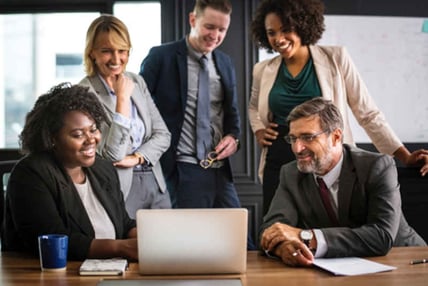 Group of people looking at computer