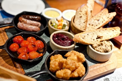 Plate with sausage, tomatoes, bread and chicken