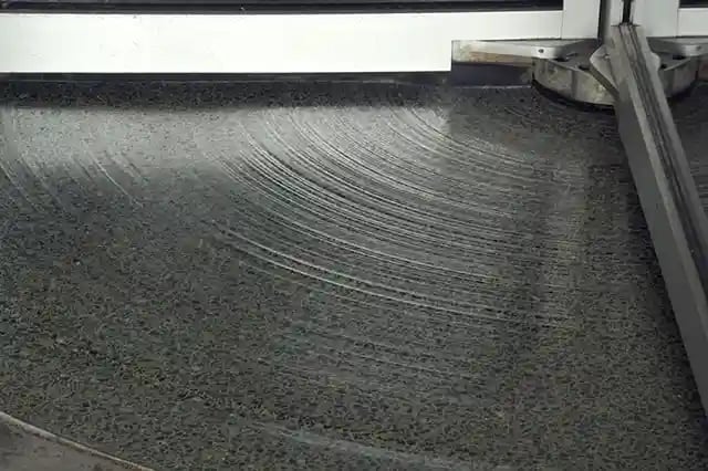 Section of grooved floor beneath revolving door