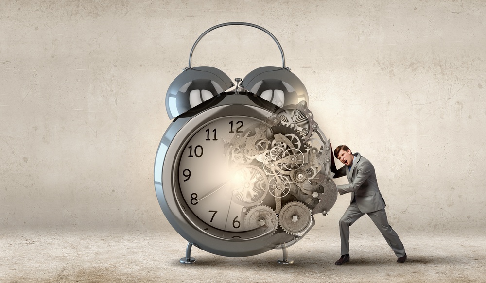 Slow websites: Businessman making effort to move alarm clock