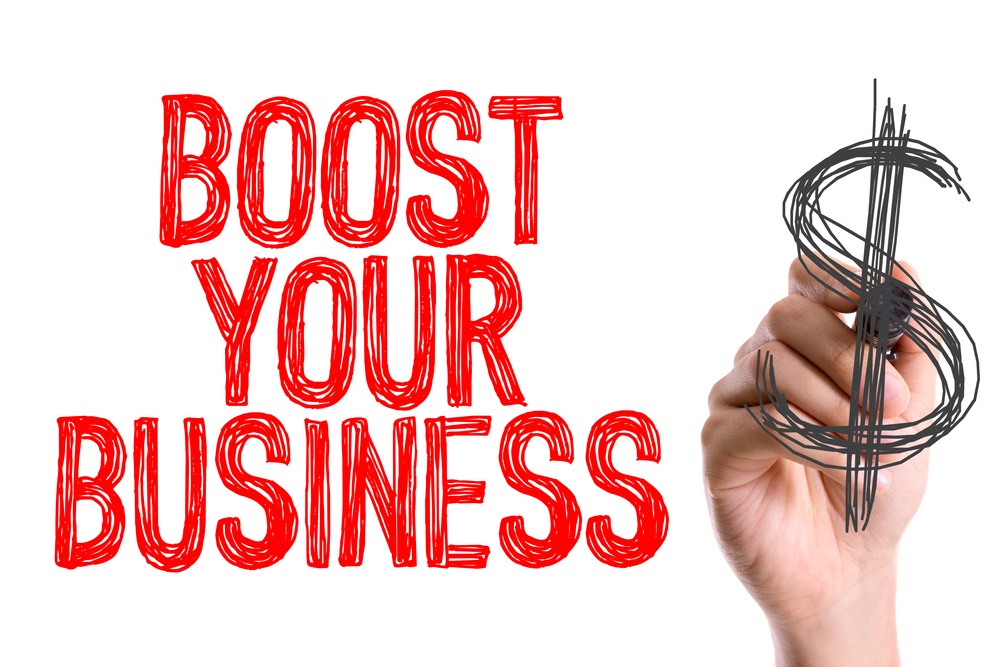 Hand with marker writing Boost Your Business with PPC