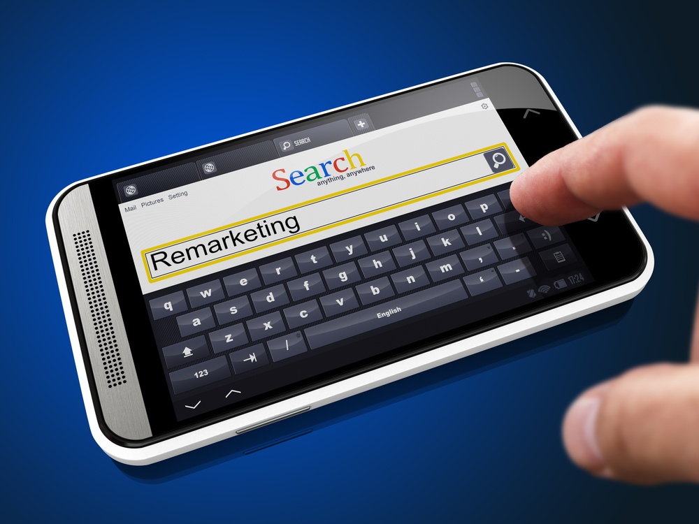 PPC Remarketing in Search String - Finger Presses the Button on Modern Smartphone on Blue Background.