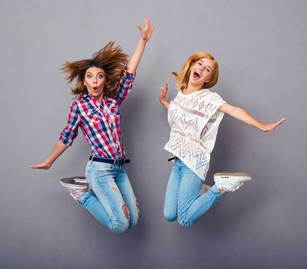 Two cheerful marketers jumping