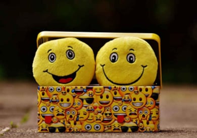 Two smiley faces in a box