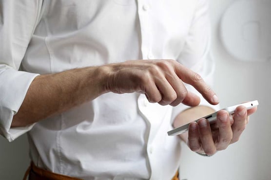 man using his smartphone white